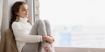 Teaching holiday consent Young girl sitting on window seat