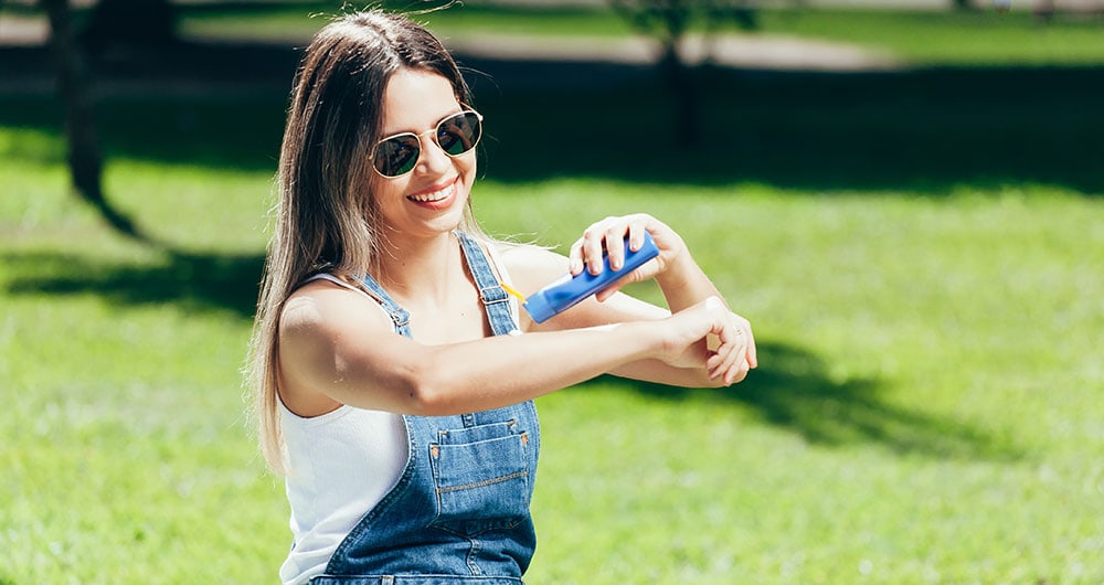 Woman applying sunscreen
