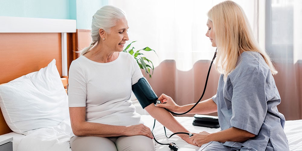 Doctor taking patient's blood pressure