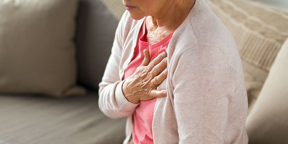 Older woman holding chest