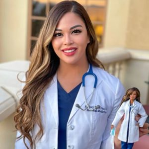 Dr. Audrey Sue Cruz holding her Barbie