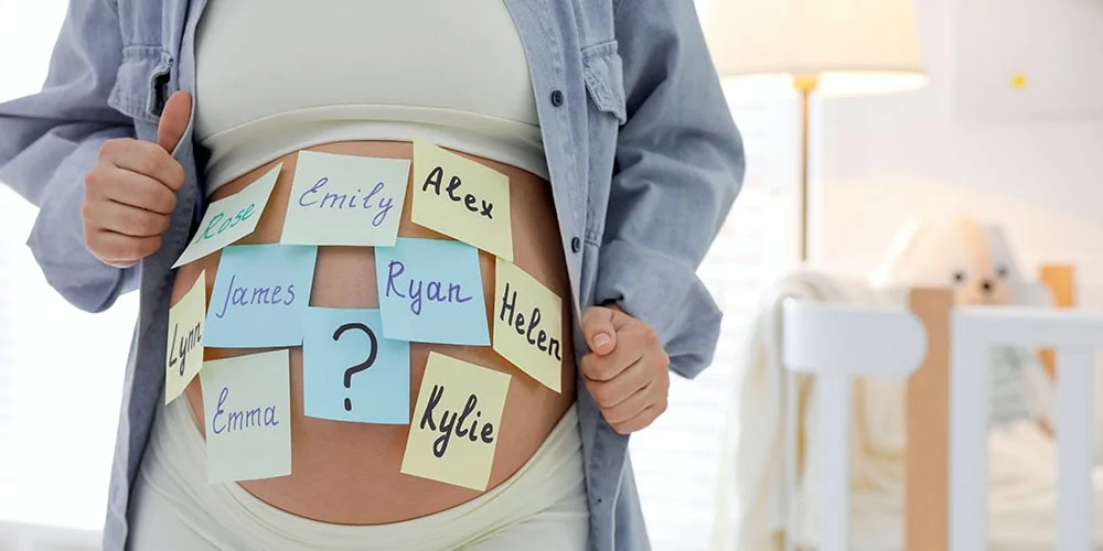Pregnant woman with baby name sticky notes on stomach