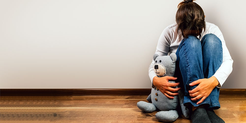 Sad woman with teddy bear