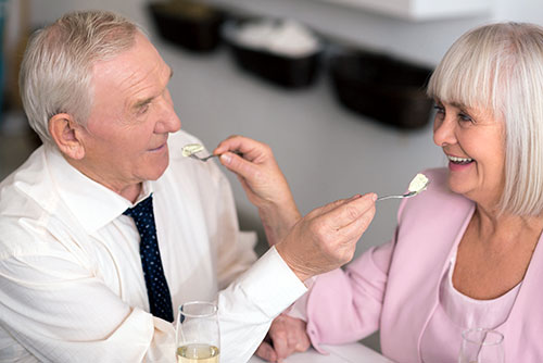 Older couple sharing dessert