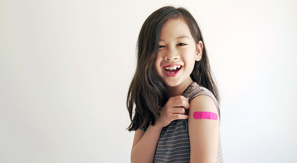 Smiling girl with HPV vaccine