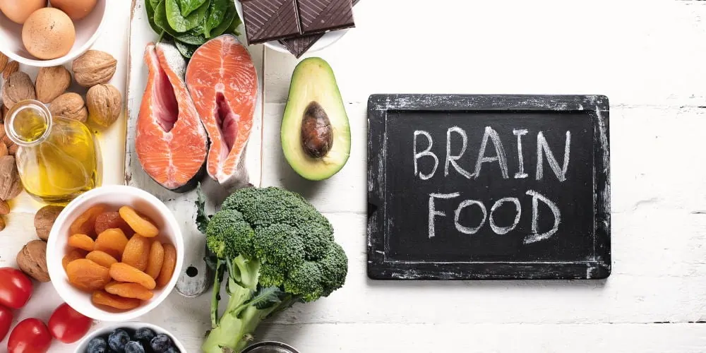 Healthy foods beside a chalk sign that says "Brain Food."