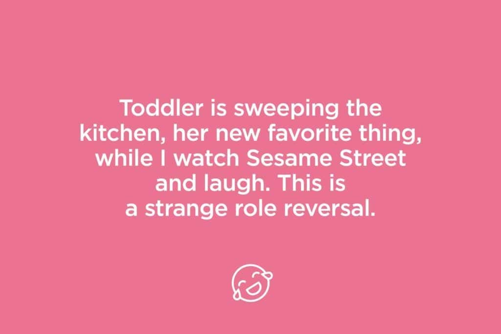 toddler is sweeping the kitchen