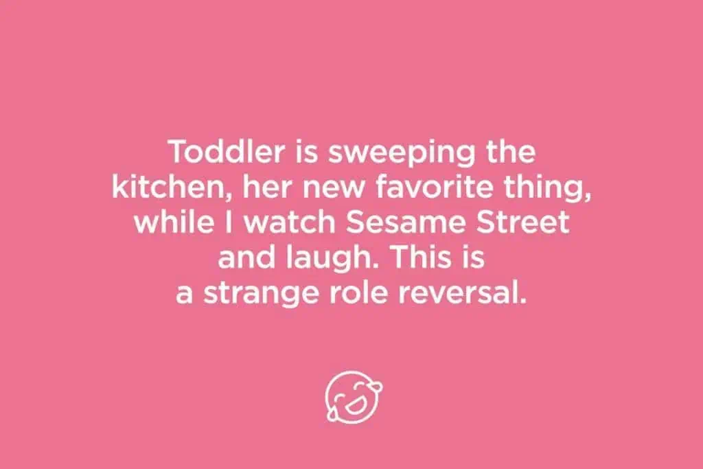 toddler is sweeping the kitchen