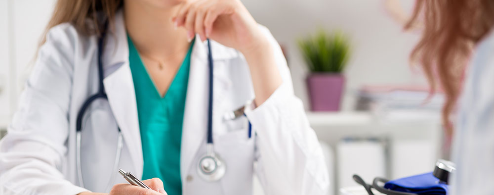 Woman talking to doctor, Dr. Thais Aliabadi OBGYN