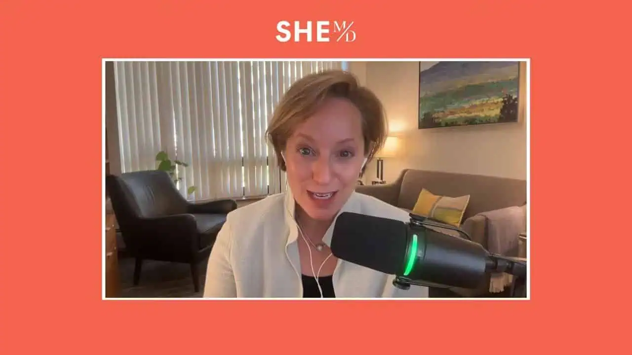 Thais Aliabadi MD speaking into microphone in a professional setting.