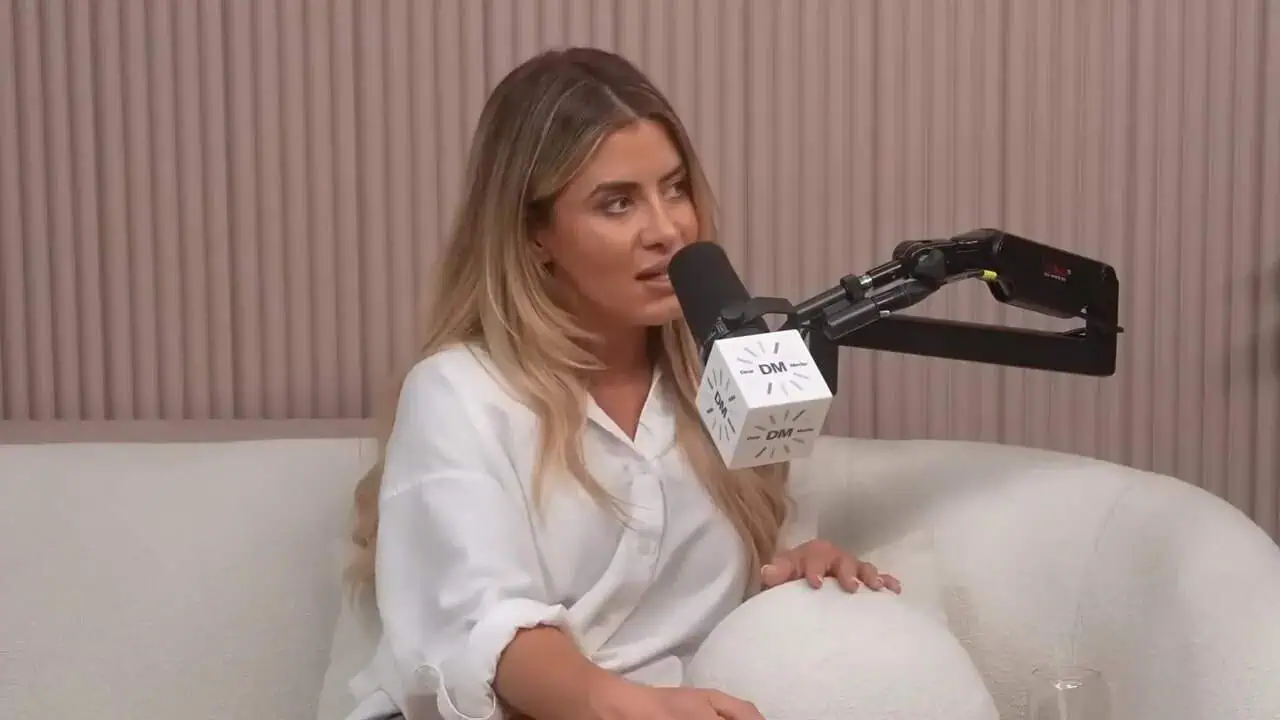 Dr. Thais Aliabadi speaking into microphone during interview or podcast.