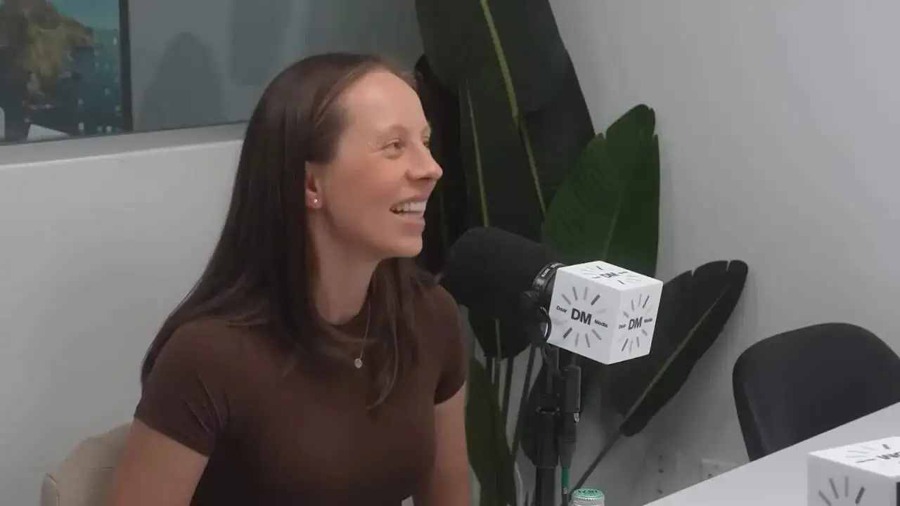 Dr. Thais Aliabadi speaking into microphone during interview or podcast.