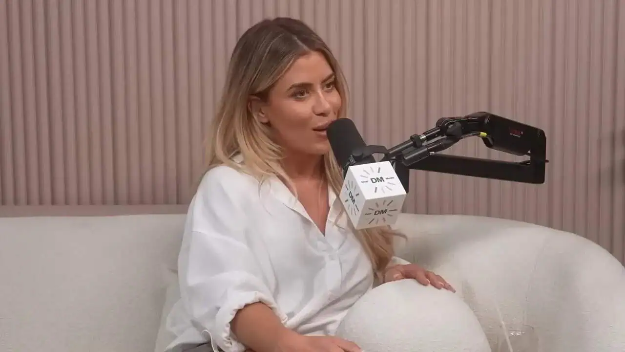 Thais Aliabadi MD speaking into a microphone during a podcast interview.