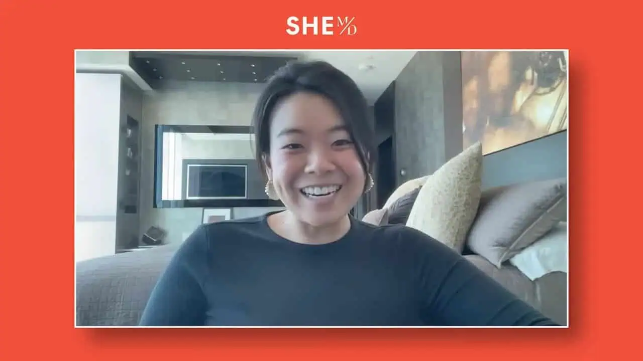 Thais Aliabadi MD smiling in a modern medical office setting.