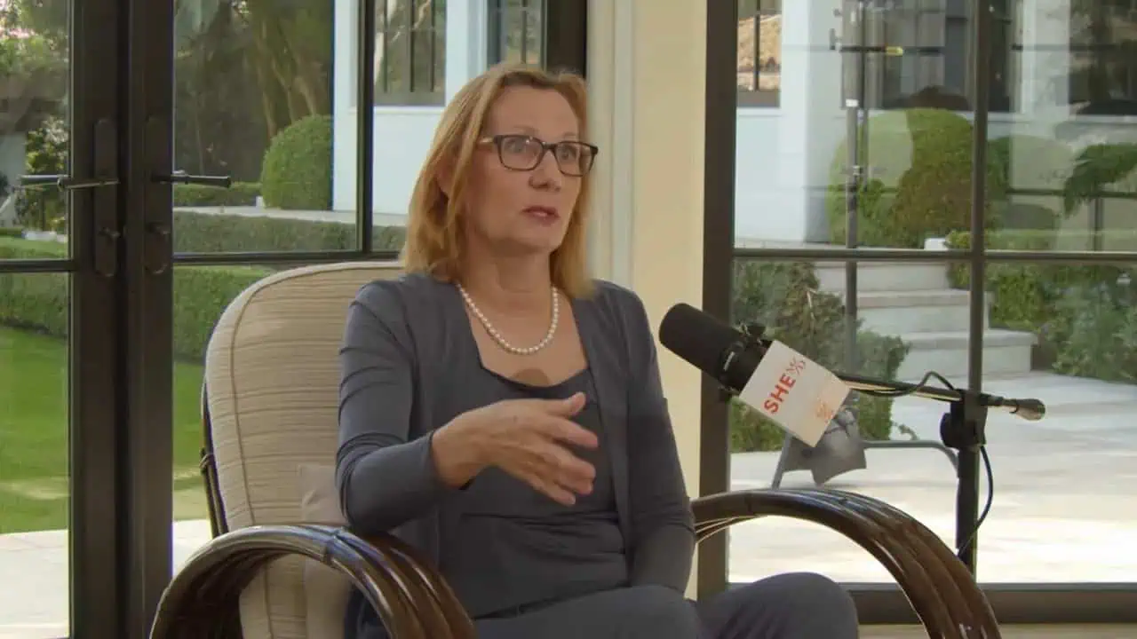 Thais Aliabadi MD speaking during an interview in a modern office setting.