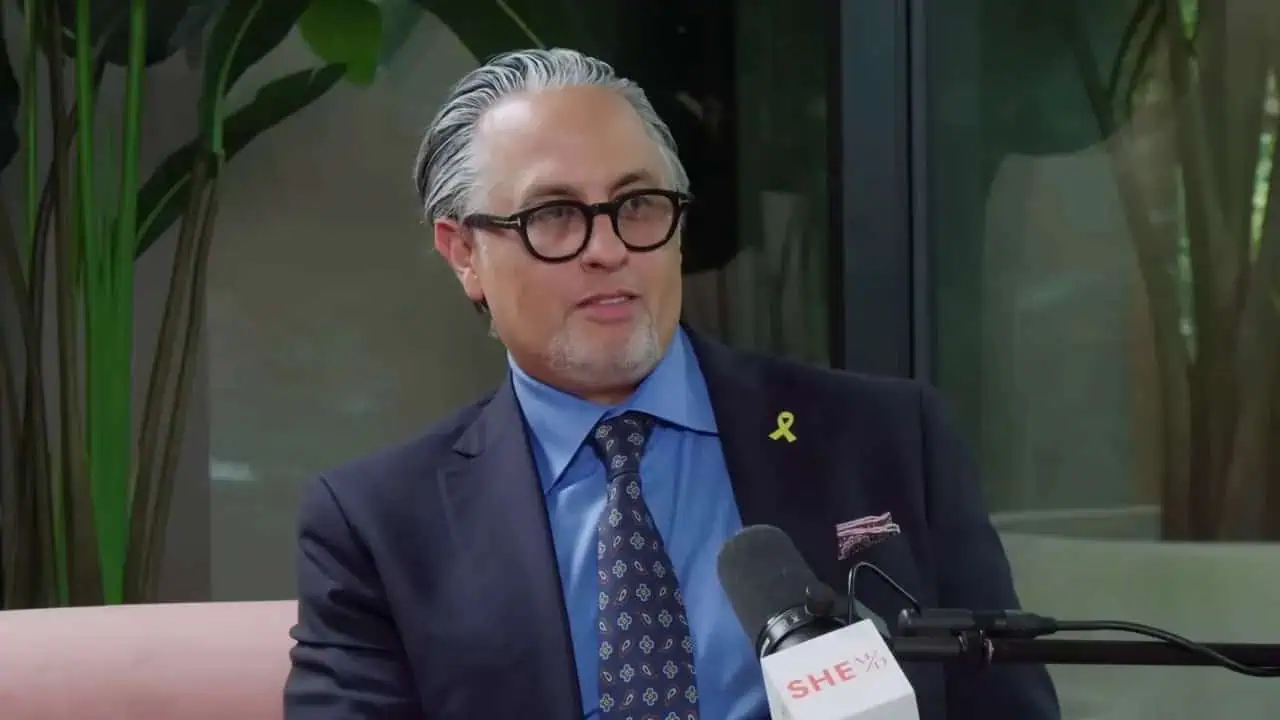 Dr. Omid Hamid speaking into a studio microphone during a melanoma interview