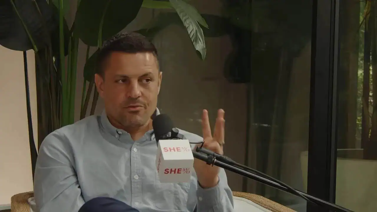 Dr. Thais Aliabadi speaking into a microphone during a medical interview.