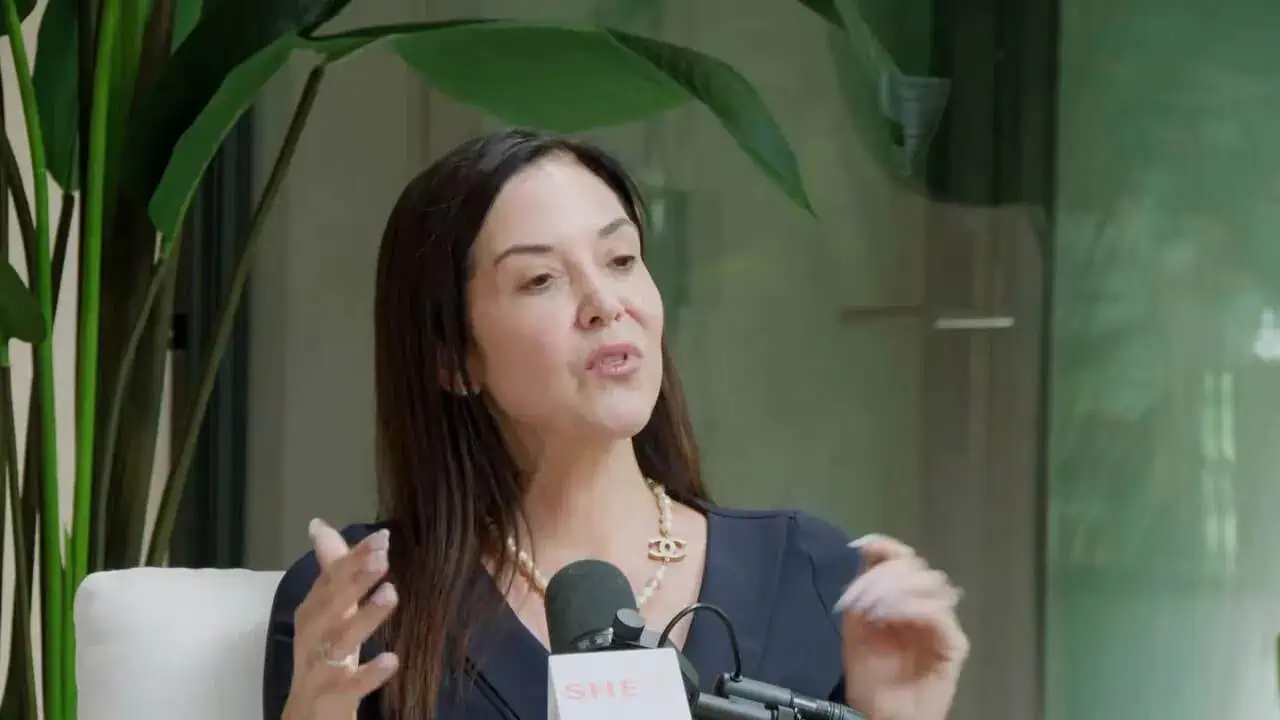 Thais Aliabadi MD speaking at a medical event or conference.