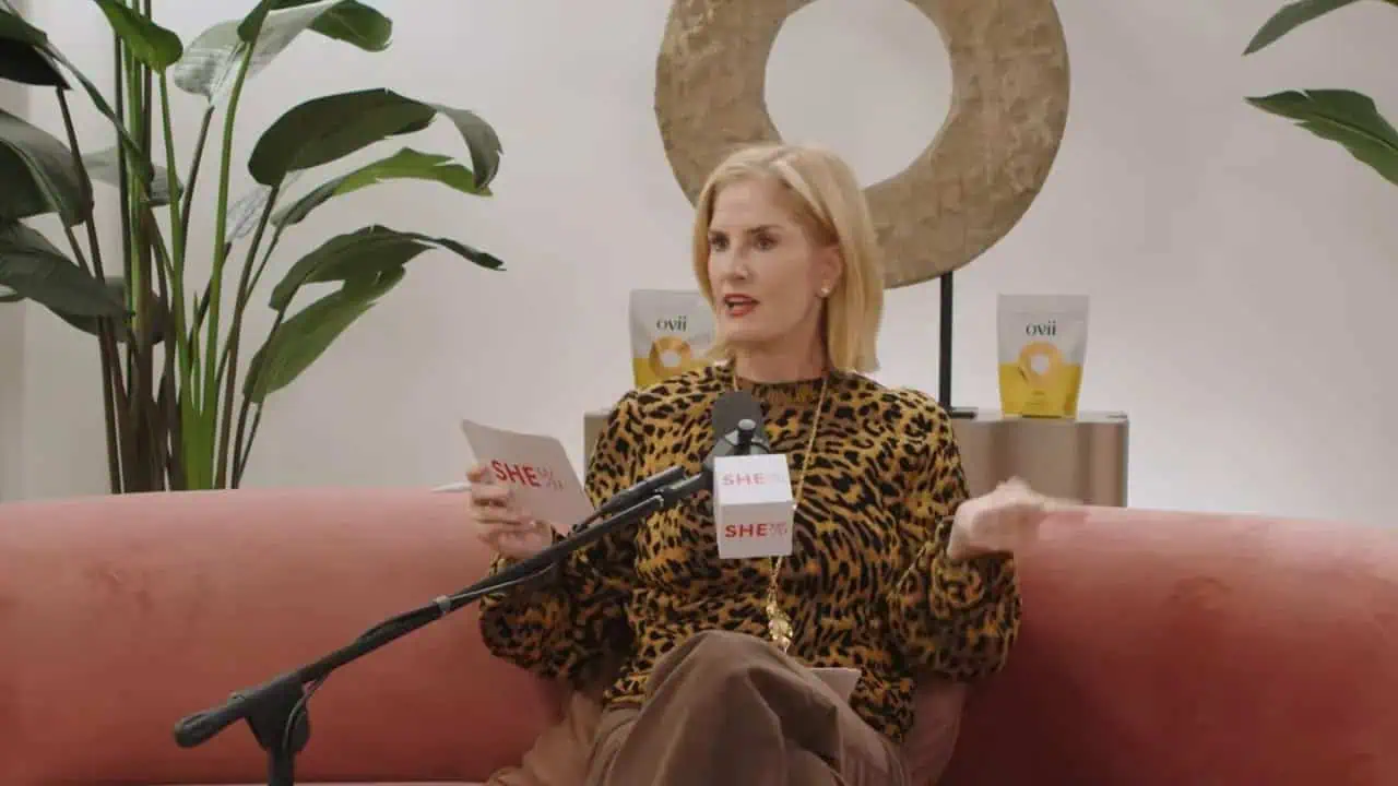 Thais Aliabadi MD speaking during a media interview in a modern clinic setting.