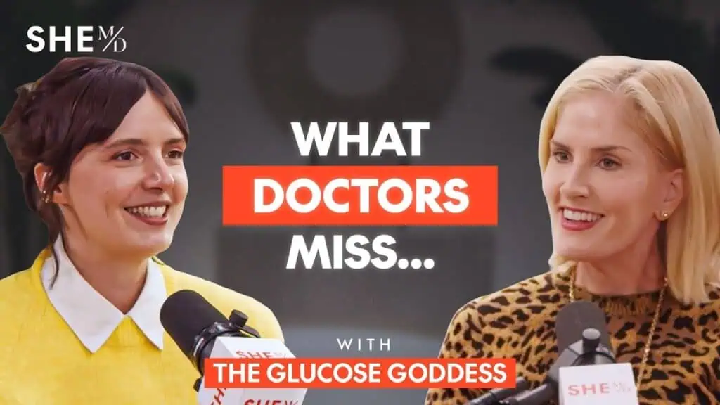 Thais Aliabadi MD speaking at a medical conference with a colleague.