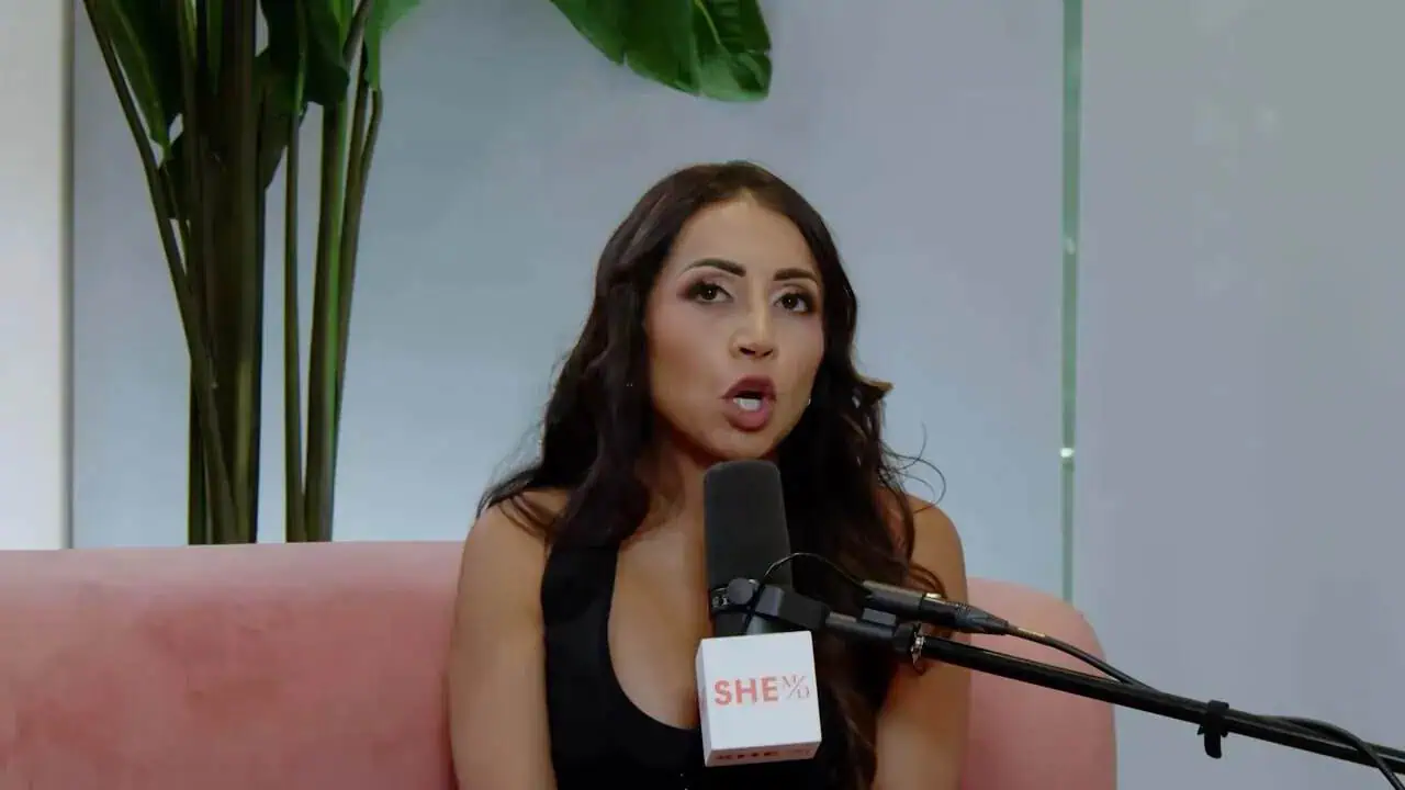 Dr. Thais Aliabadi speaking into a microphone during an interview.
