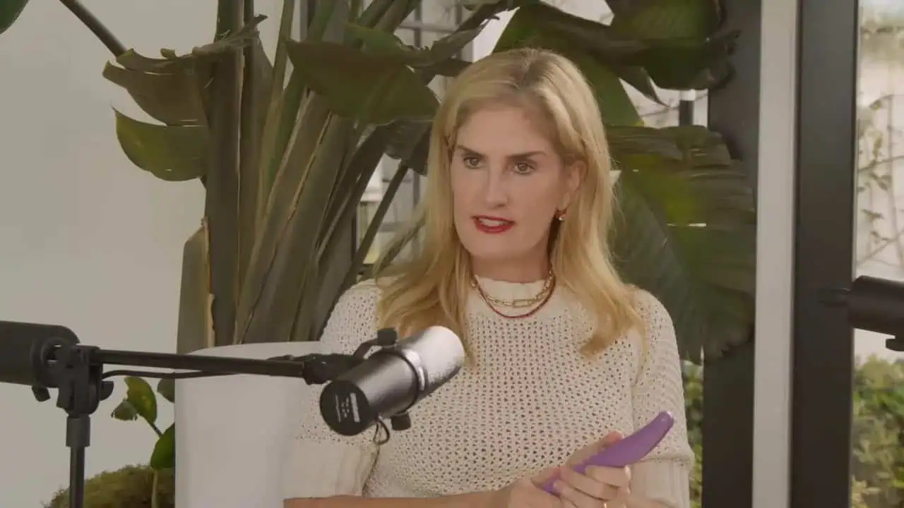 Portrait of Thais Aliabadi MD speaking into a microphone during an interview.
