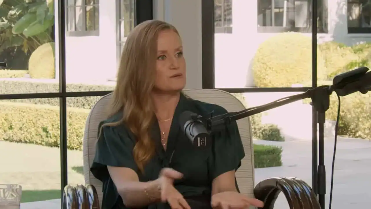 Dr. Thais Aliabadi speaking into a microphone during an interview about postpartum pelvic health and painful sex