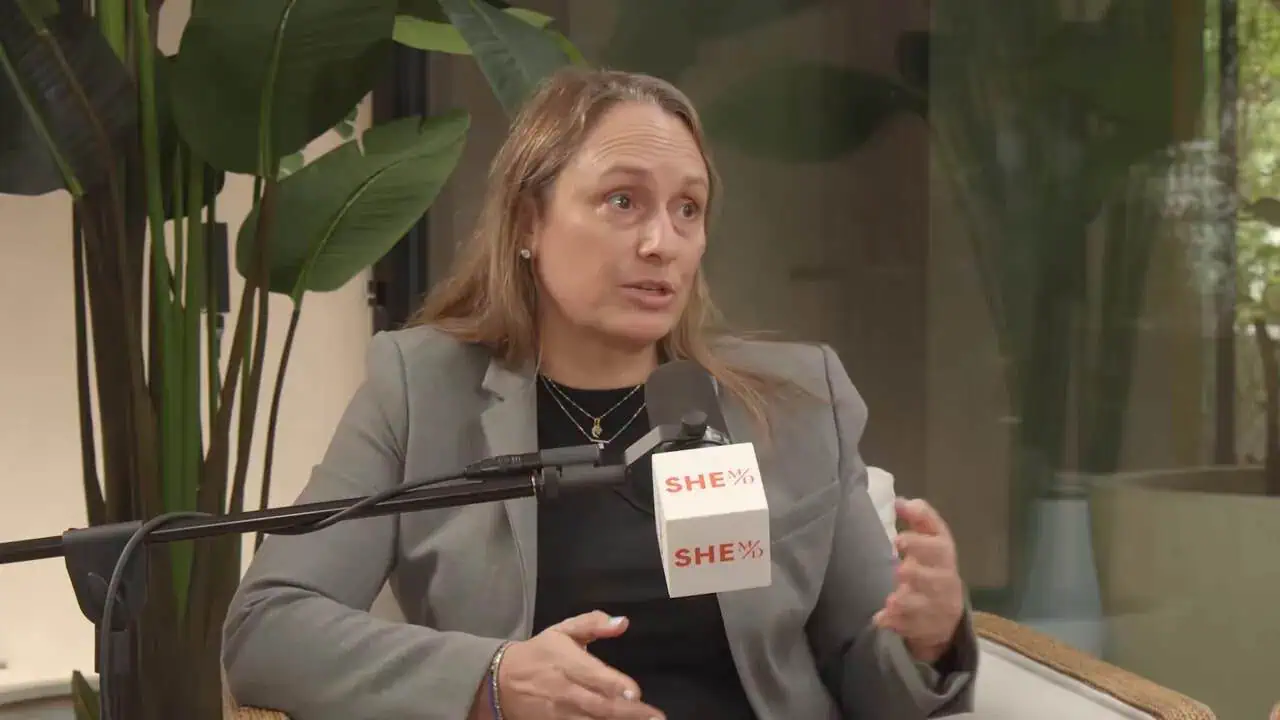 Thais Aliabadi MD speaking at a medical conference, discussing healthcare topics.