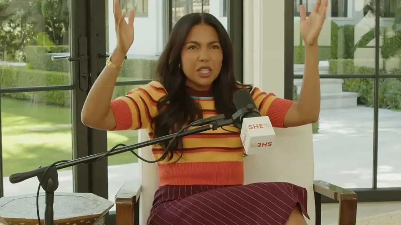 Emma Grede speaking confidently during an interview with her hands raised