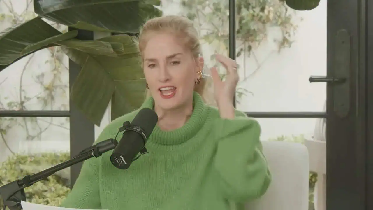 Mary Alice speaking and gesturing during a podcast interview
