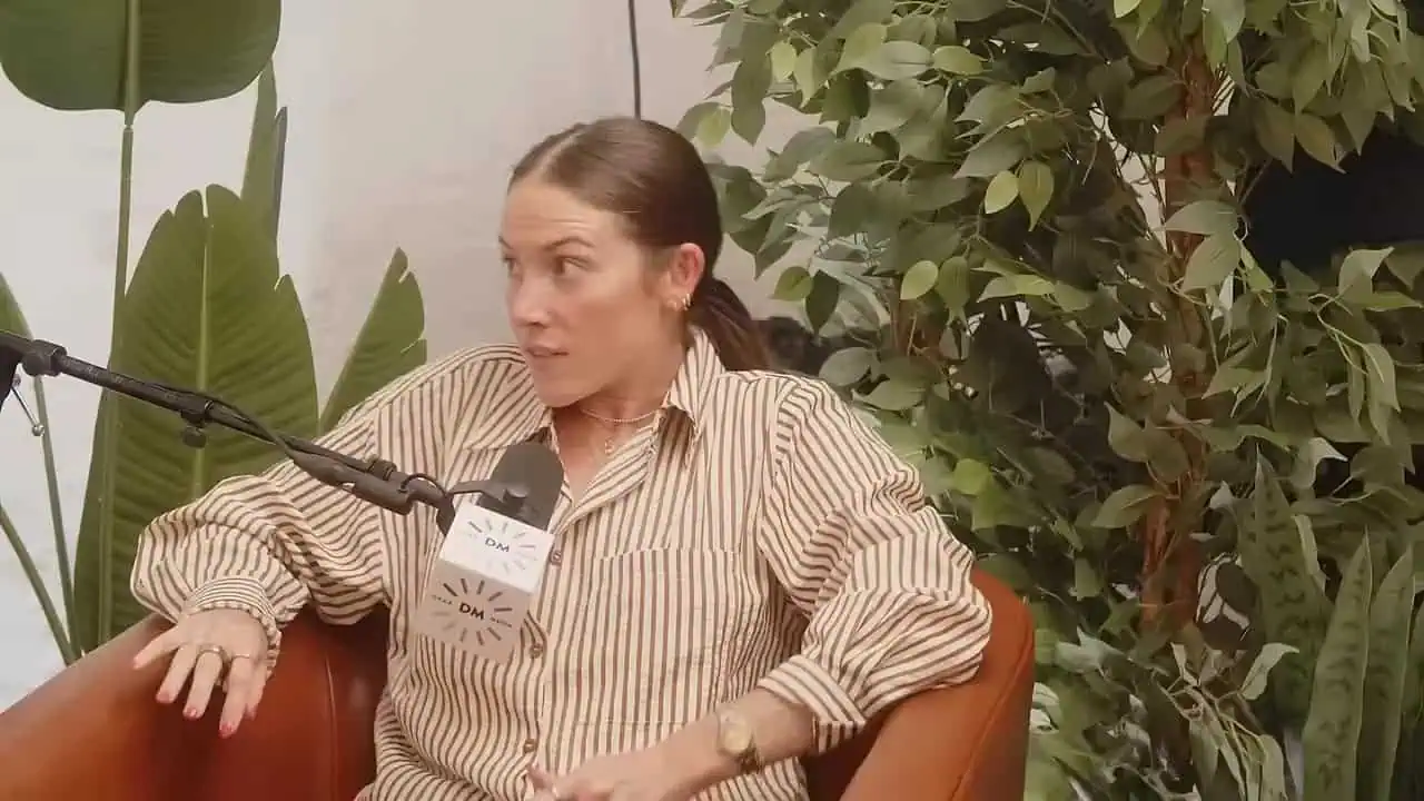 Thais Aliabadi MD speaking during an interview in a lush setting.