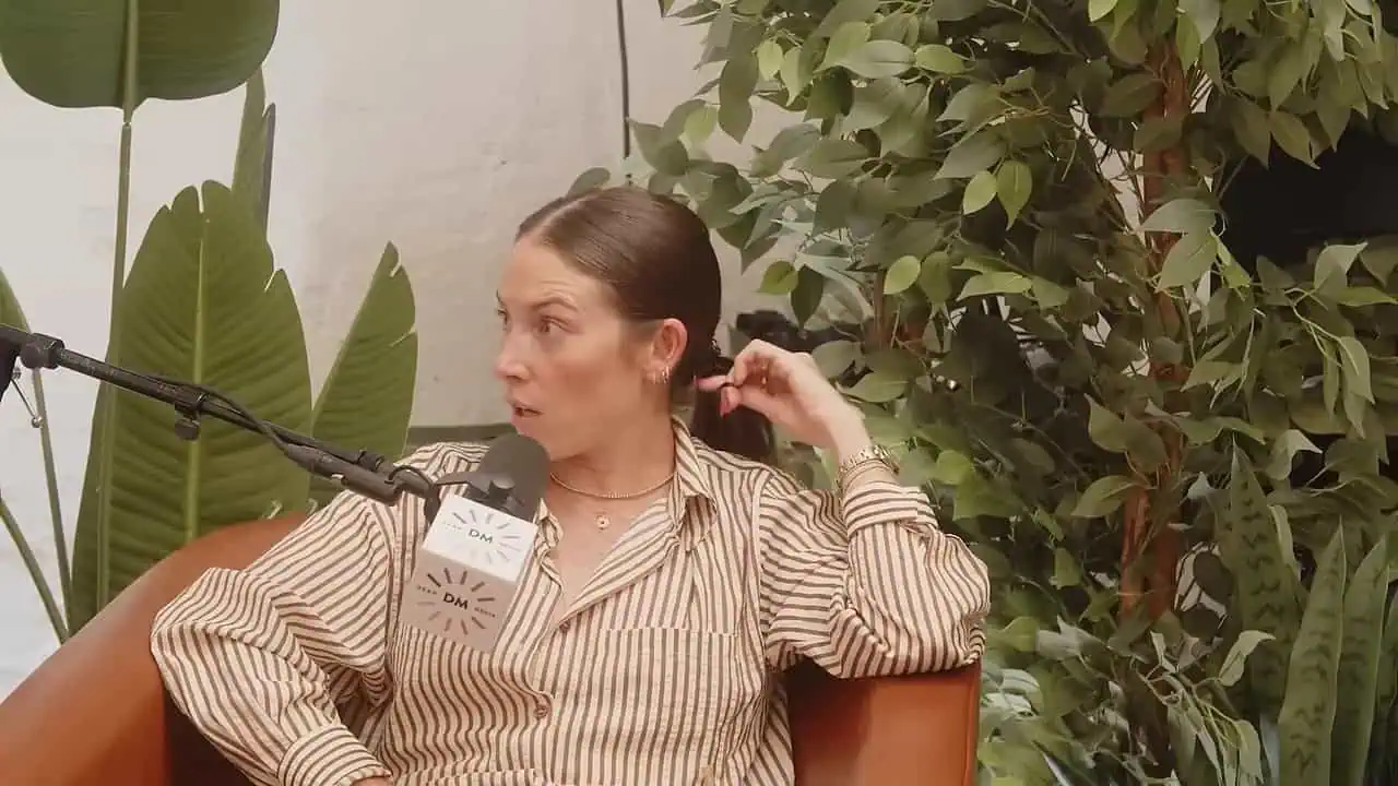 Thais Aliabadi MD speaking into a microphone during a podcast recording.