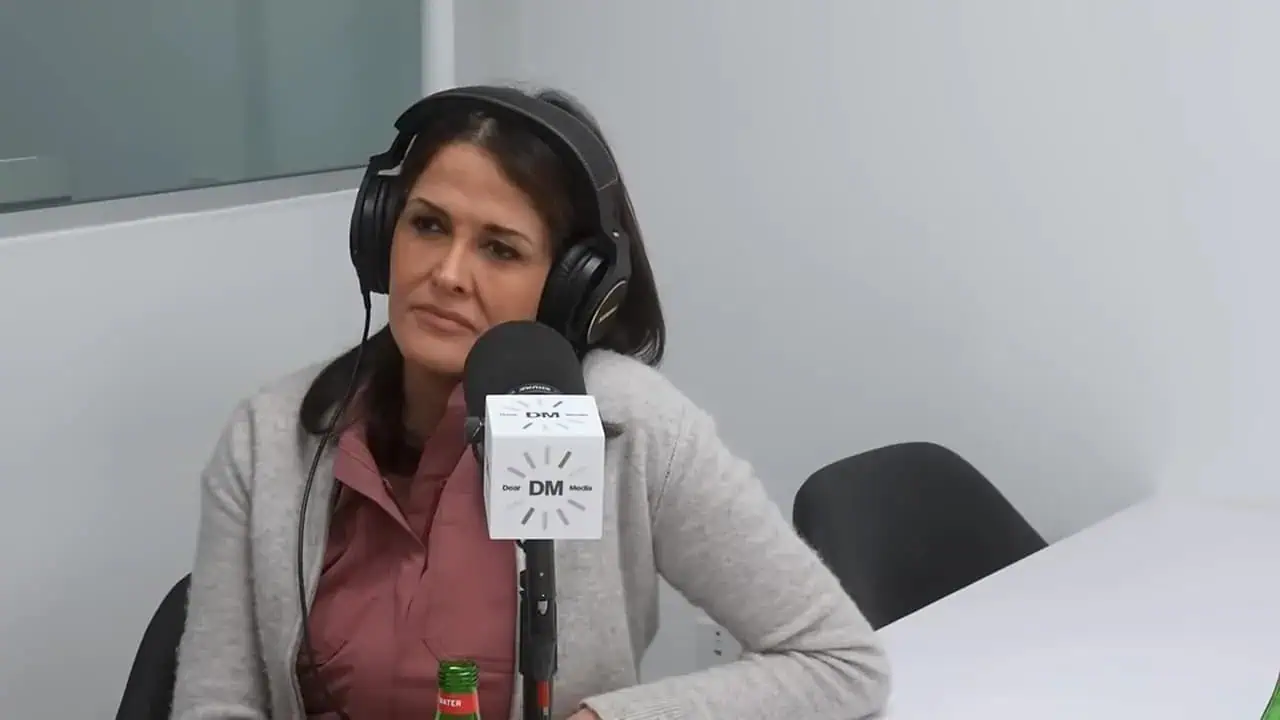 Thais Aliabadi MD speaking into microphone during a podcast.