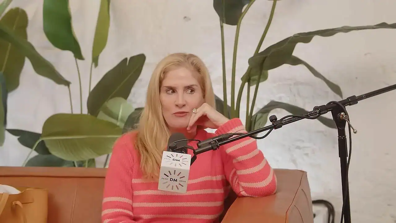 Thais Aliabadi MD speaking at a podcast with plants in the background.