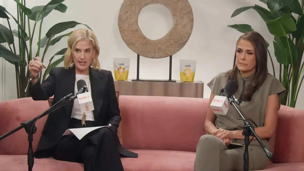Dr. Thais Aliabadi speaking during an interview on a pink sofa.