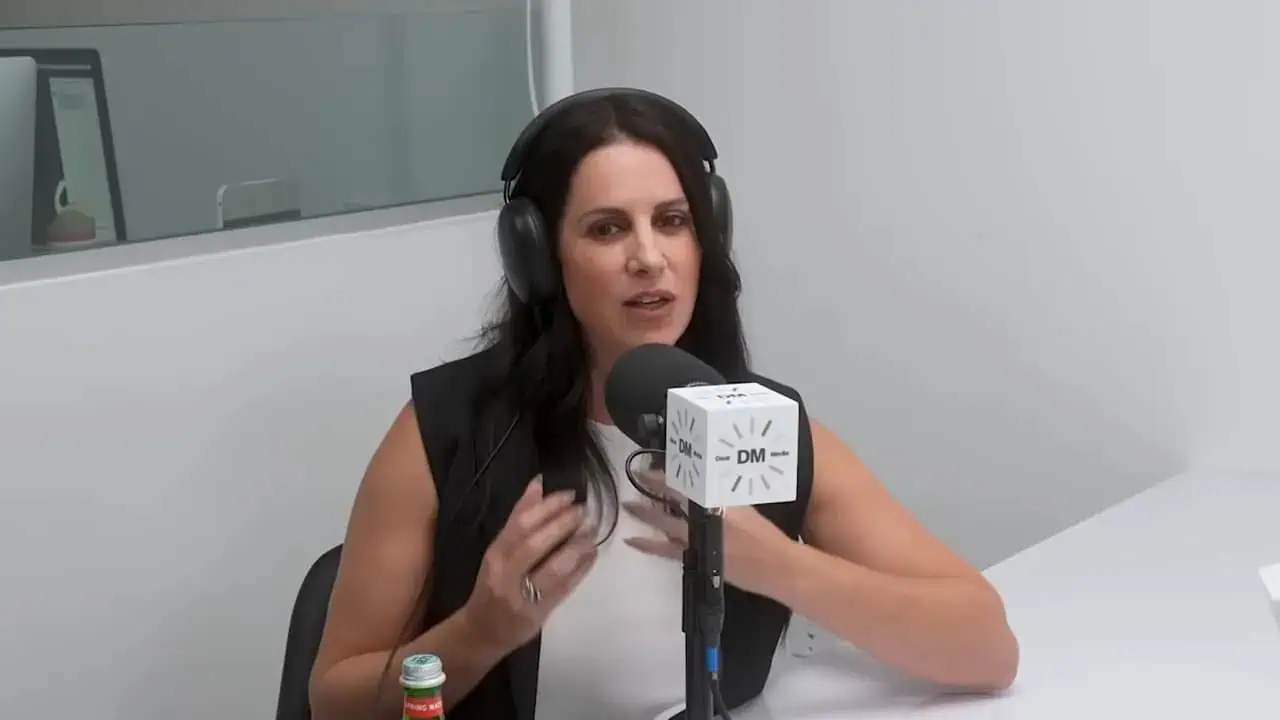 Thais Aliabadi MD speaking into microphone during medical podcast.
