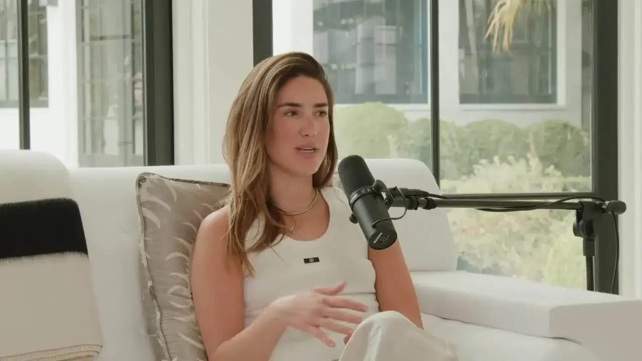 Thais Aliabadi MD speaking during an interview in a modern office setting.