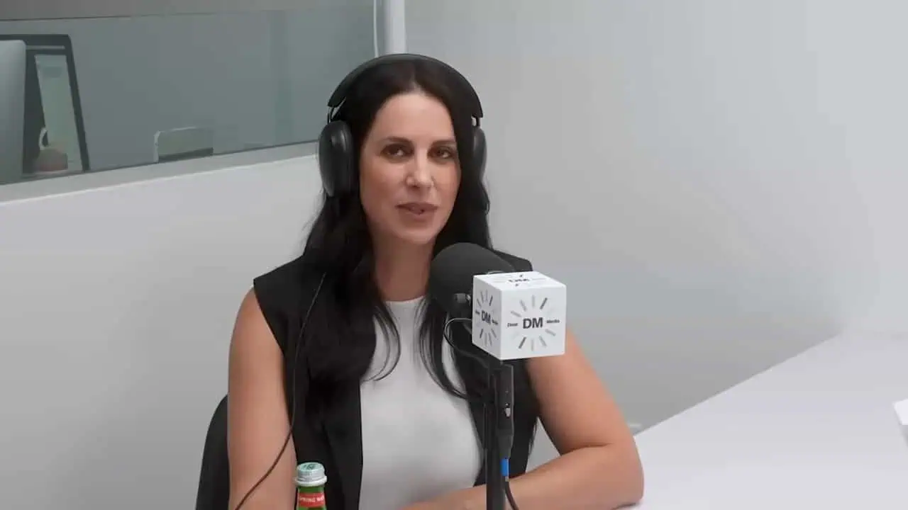Thais Aliabadi MD speaking into microphone during podcast recording.