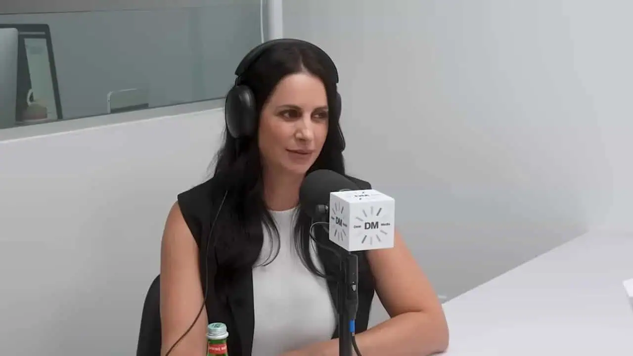 Thais Aliabadi MD speaking into microphone during podcast recording.