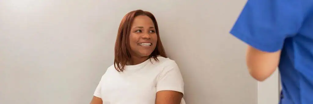 Smiling female patient during gynecological consultation in Los Angeles.