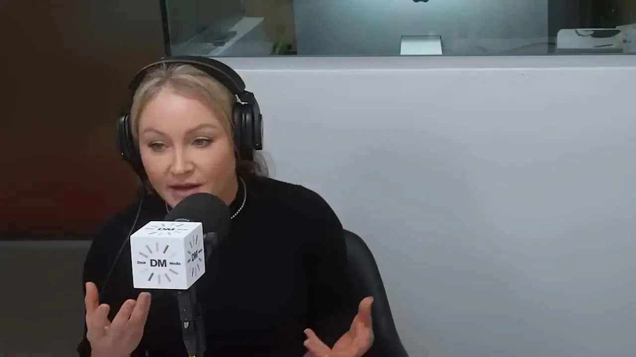 Thais Aliabadi MD speaking into microphone during radio interview.
