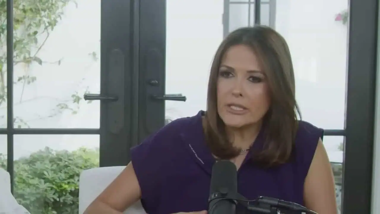 doctor speaking in a purple dress while seated in the studio