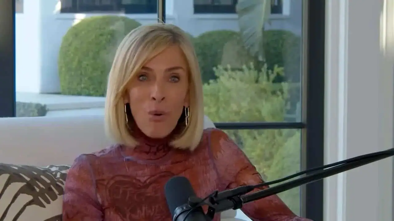 Thais Aliabadi MD in a professional setting with a microphone.