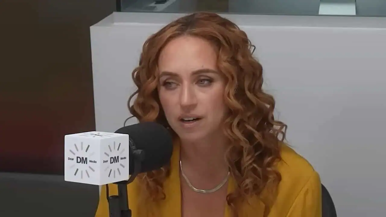 Thais Aliabadi MD speaking into microphone at interview.