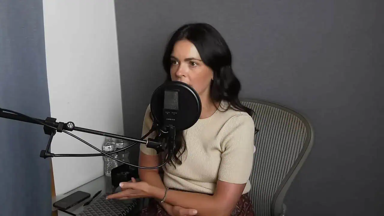 Thais Aliabadi MD speaking into microphone during podcast recording.