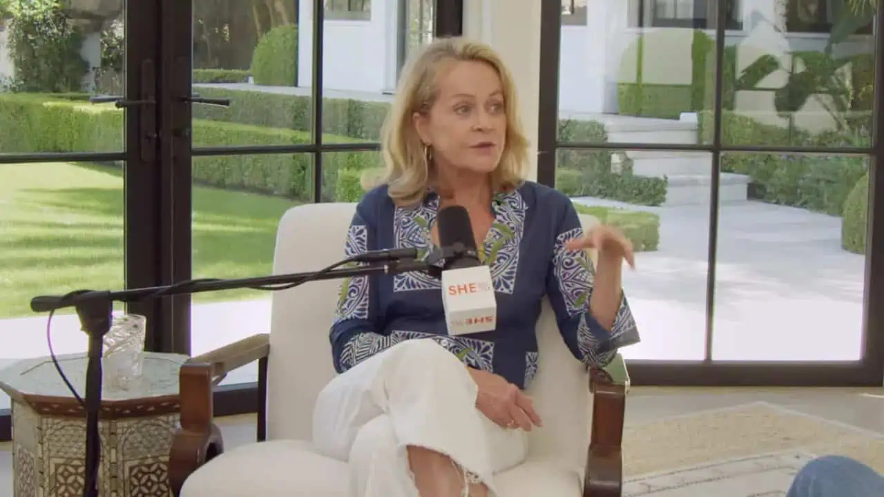 Kristen Coffield speaking into a microphone while seated in a bright room