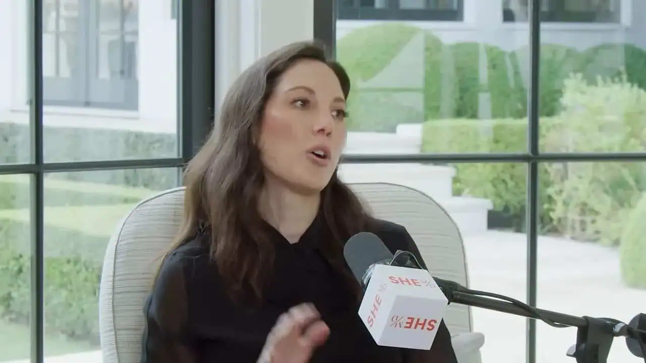 Thais Aliabadi MD speaking at a conference or interview.