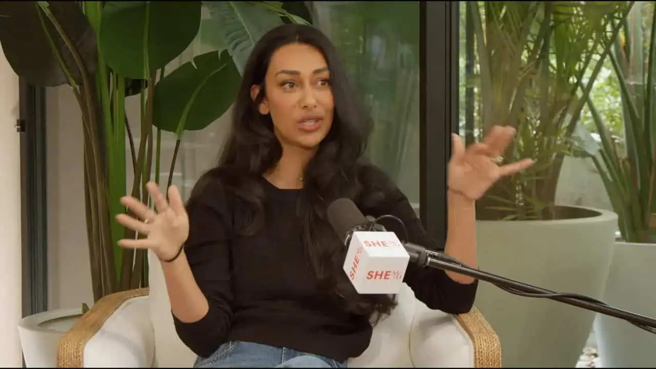 Thais Aliabadi MD speaking during an interview with a microphone.