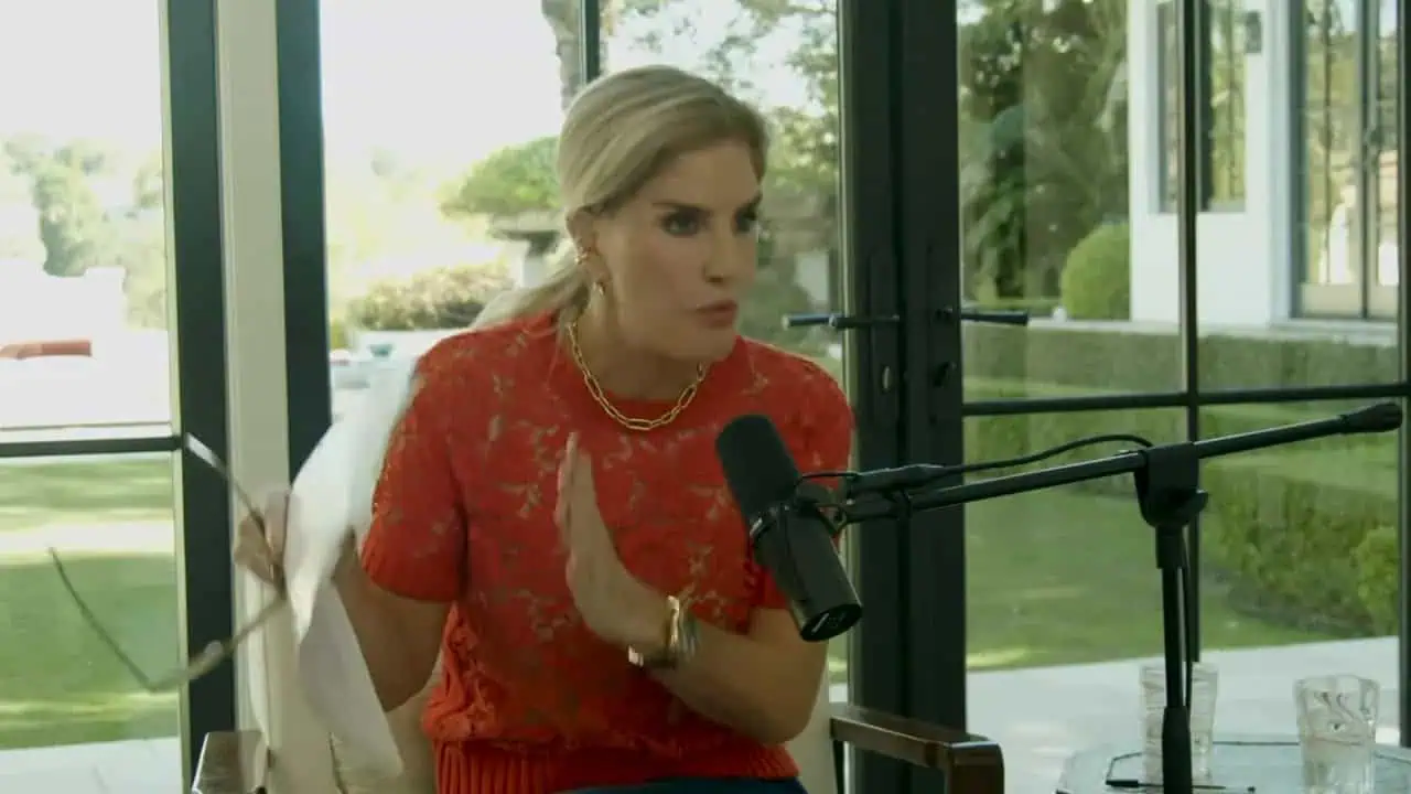 Dr. Thais Aliabadi speaking into a microphone during an interview or podcast.