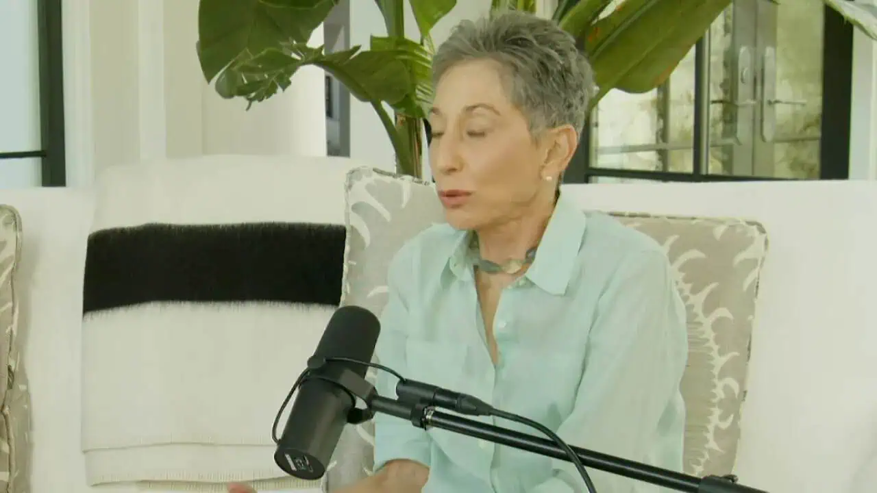 Thais Aliabadi MD speaking into a microphone in a professional setting.